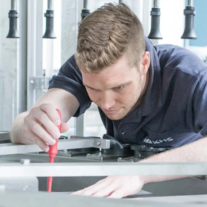 Service engineer working on industrial production equipment